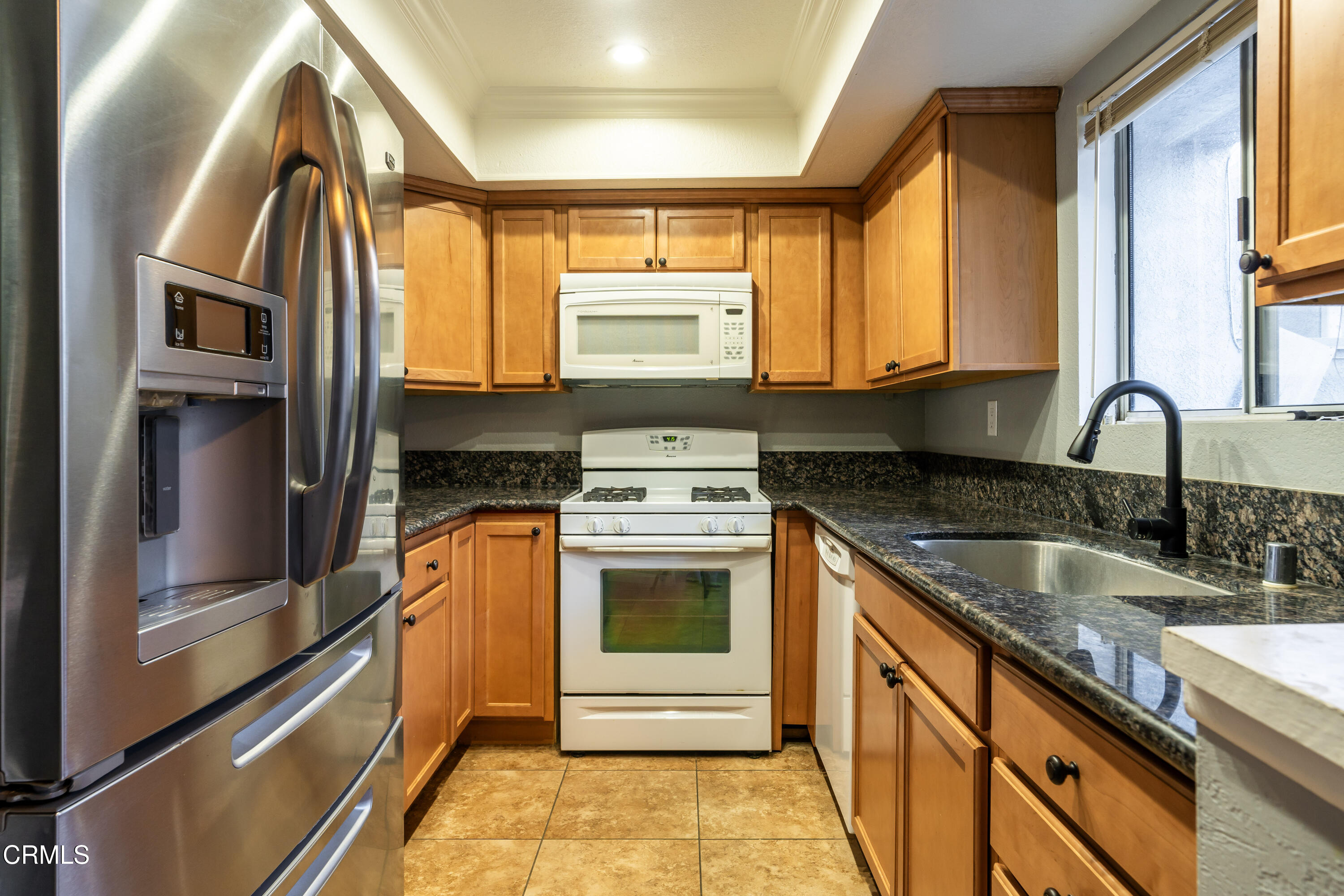 186 West Walnut Avenue, Unit E Rialto, CA 92376 - Photo 7 of 22 a kitchen with stainless steel appliances granite countertop a sink and a stove