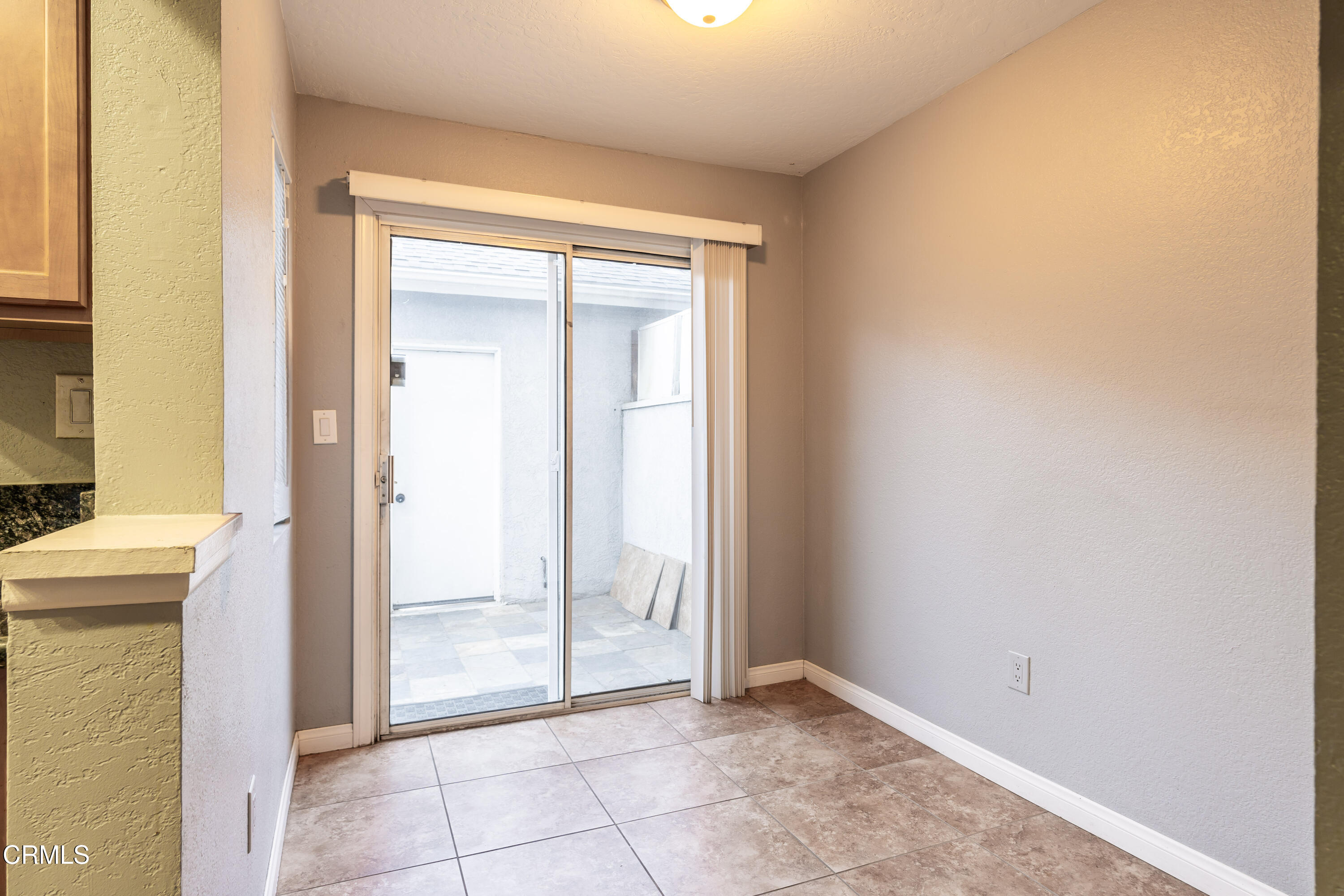 186 West Walnut Avenue, Unit E Rialto, CA 92376 - Photo 9 of 22 a view of an empty room with glass door