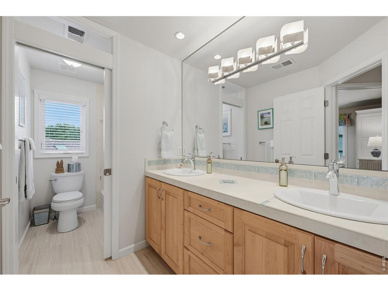 3754 Kentford Road Fort Collins, CO 80525 - Photo 35 of 50 Updated shared bath with dual-sink vanity, porcelain tile flooring & glass tile accents