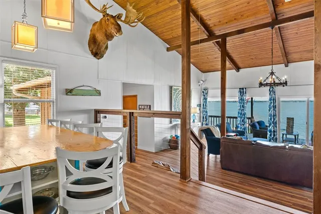 a view of a dining room with furniture a chandelier and wooden floor