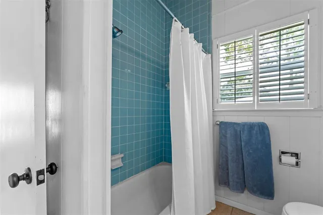 a bathroom with a shower and a toilet