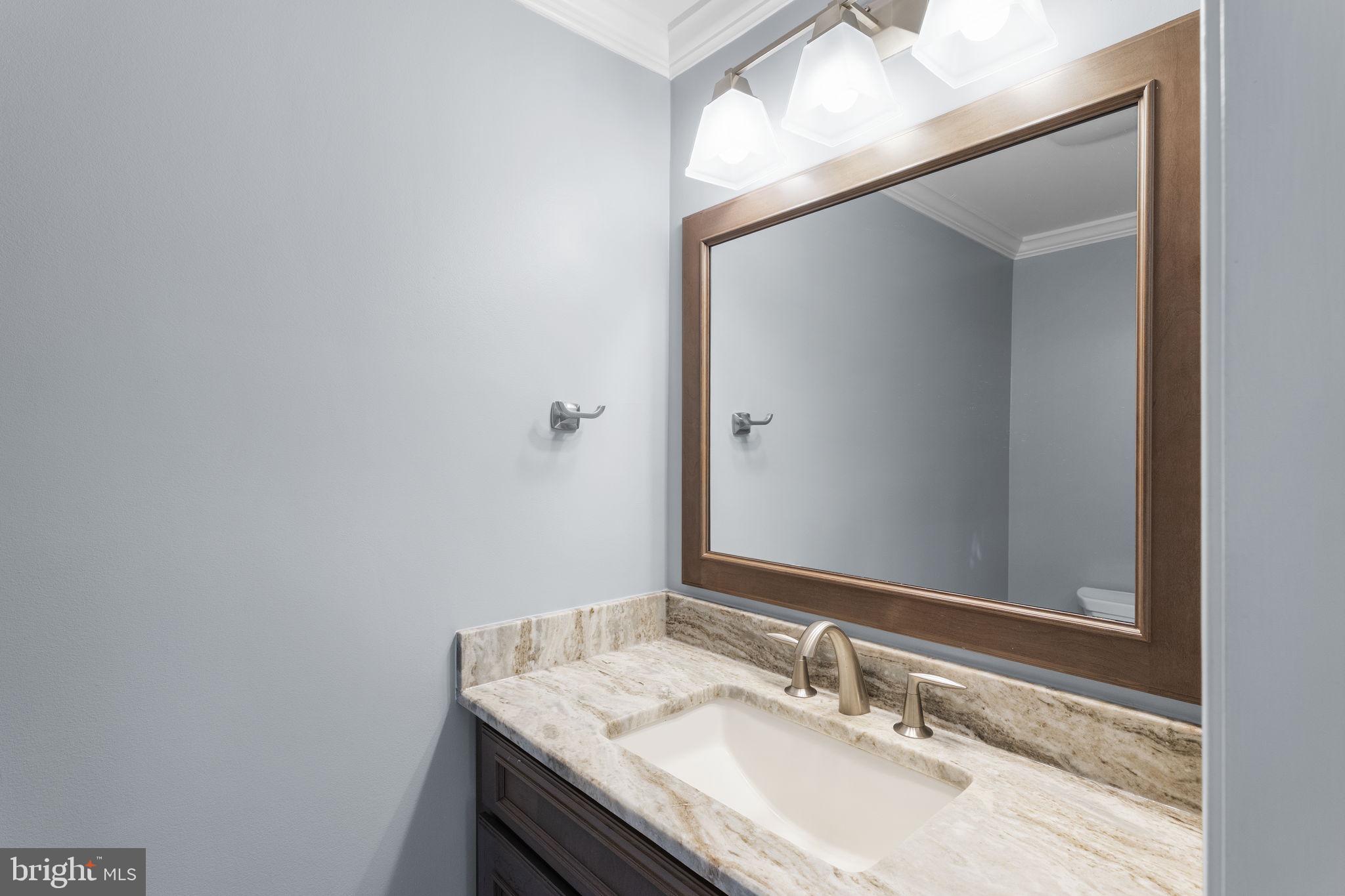 975 Phillips Drive Arnold, MD 21012 - Photo 23 of 93 a bathroom with a granite countertop sink and a mirror