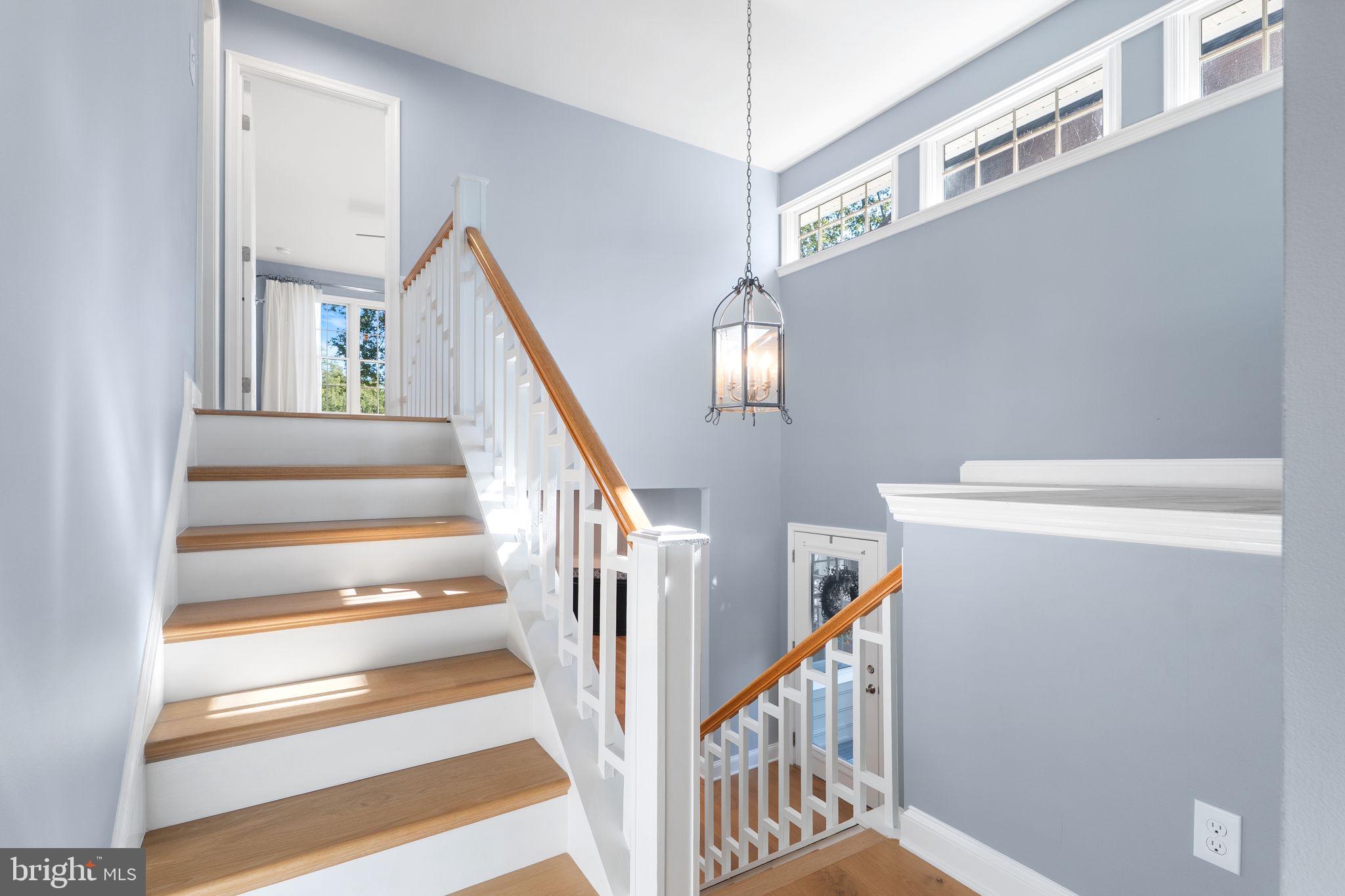 975 Phillips Drive Arnold, MD 21012 - Photo 31 of 93 a view of staircase with lots of frames on wall and a chandelier