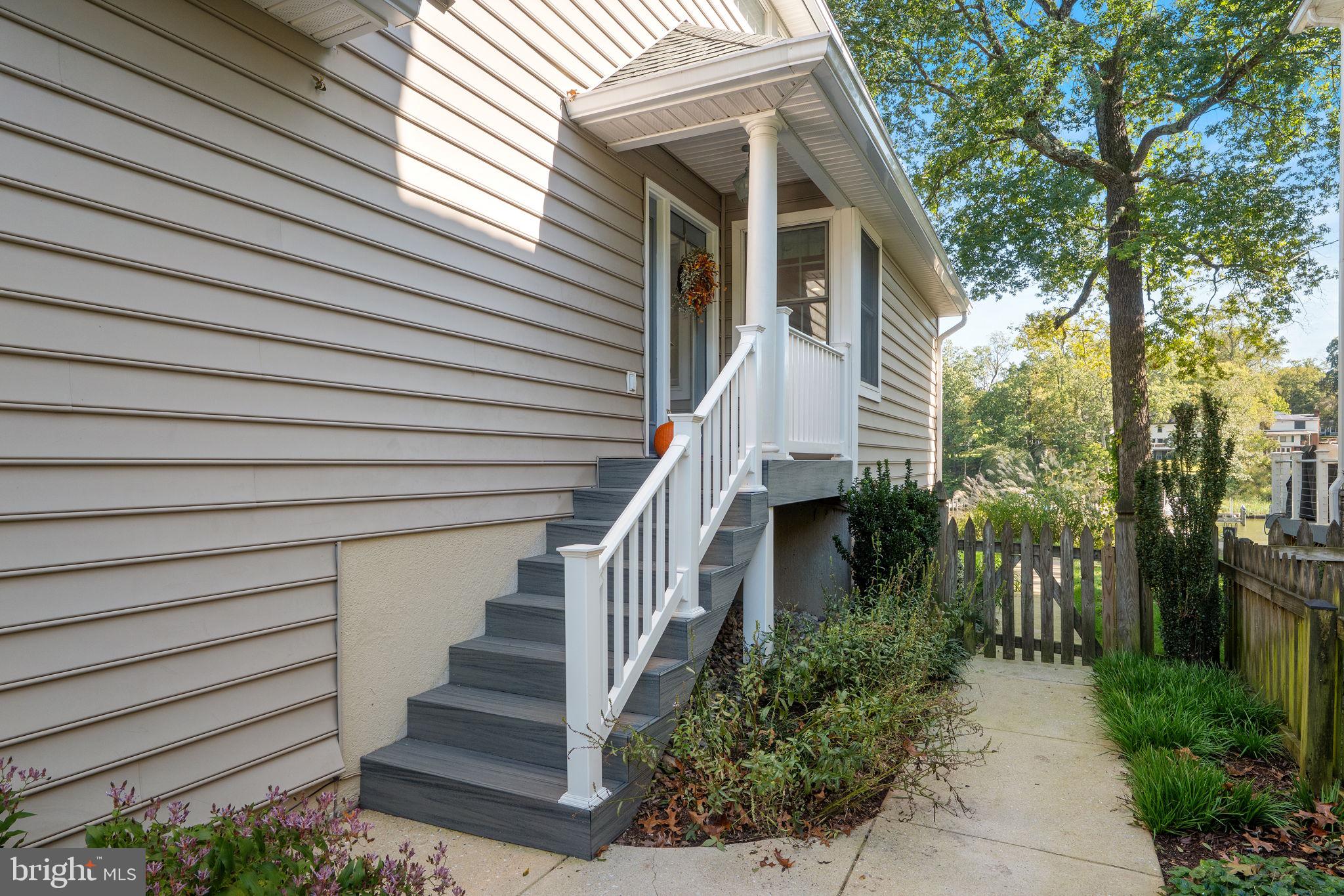 975 Phillips Drive Arnold, MD 21012 - Photo 4 of 93 a view of a house with wooden stairs and a small yard