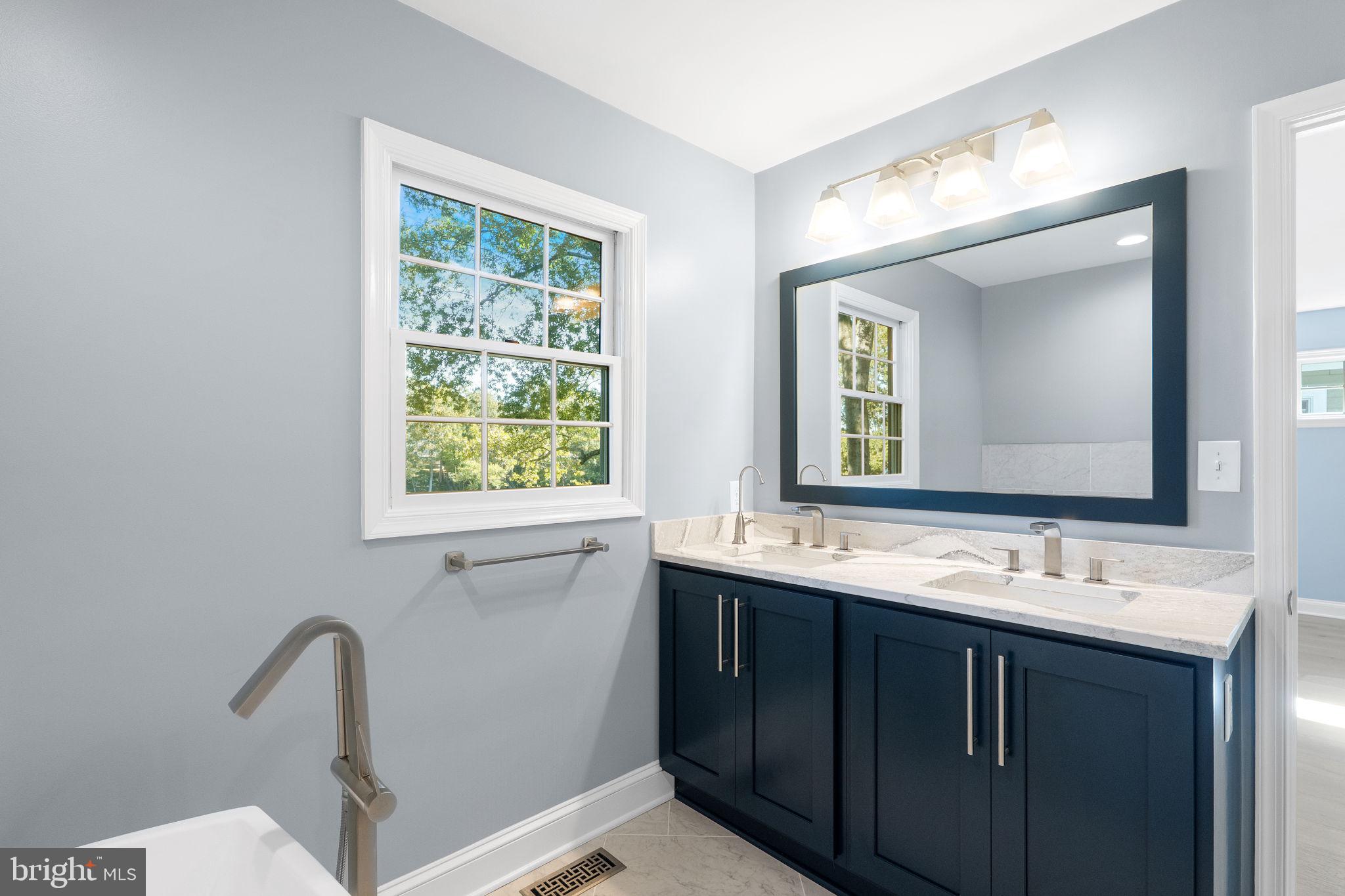 975 Phillips Drive Arnold, MD 21012 - Photo 43 of 93 a bathroom with a double vanity sink and mirror