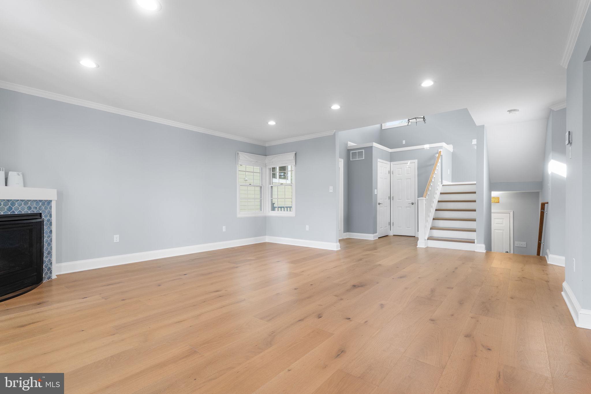 975 Phillips Drive Arnold, MD 21012 - Photo 6 of 93 a view of empty room with wooden floor and fireplace