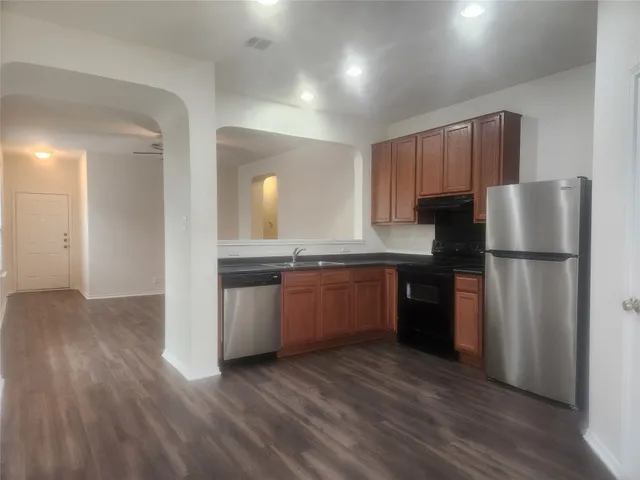 a kitchen with a refrigerator and a sink