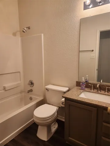 a bathroom with a toilet a sink and bathtub