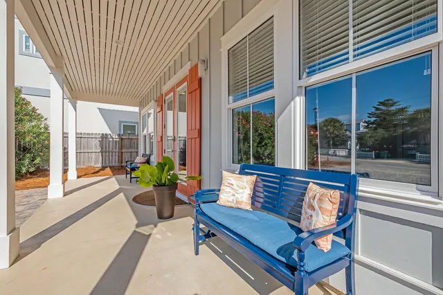 a view of a balcony with wooden floor and fence