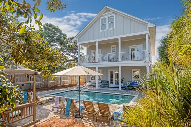 a view of house with swimming pool outdoor seating