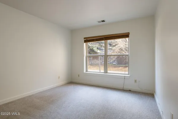 an empty room with closet area