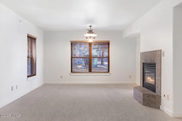 an empty room with windows and cabinet