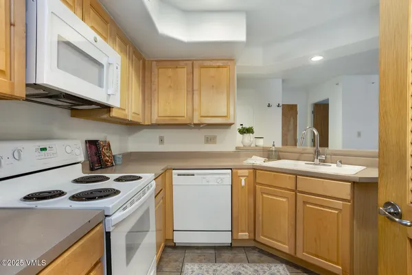 a kitchen with a sink stove top oven and cabinets