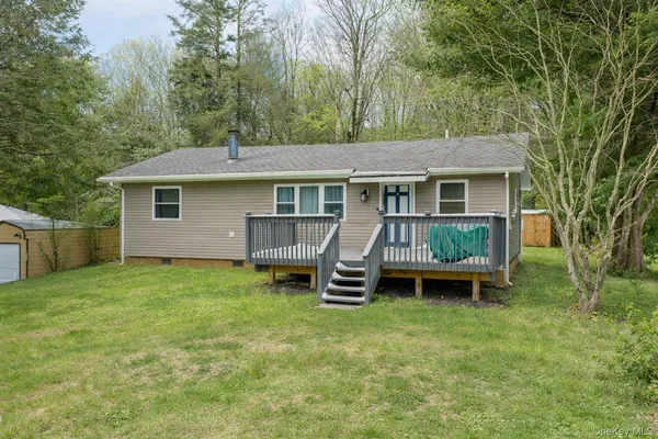 a backyard of a house with table and chairs