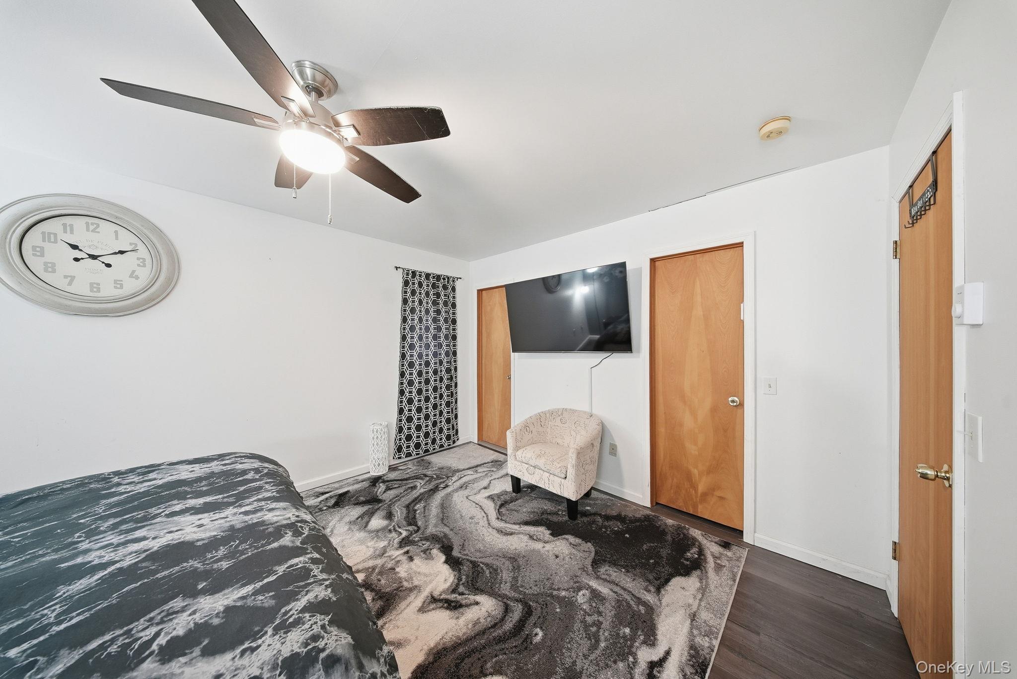 4 Ray Lane Loch Sheldrake, NY 12759 - Photo 13 of 23 a bedroom with a bed and a chandelier