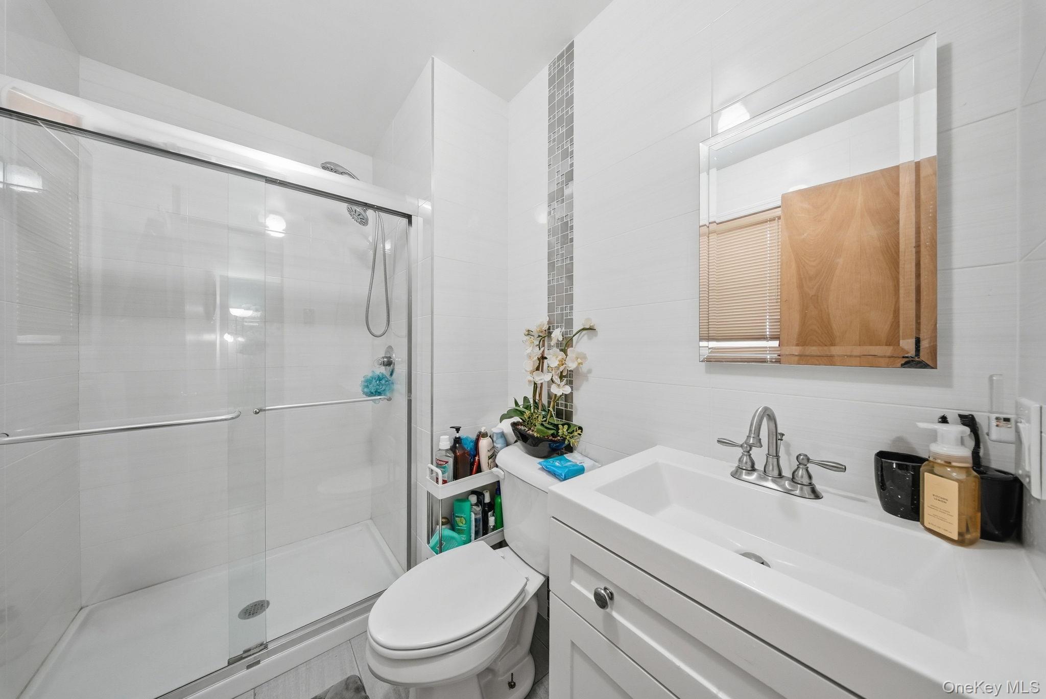 4 Ray Lane Loch Sheldrake, NY 12759 - Photo 14 of 23 a bathroom with a sink toilet and shower