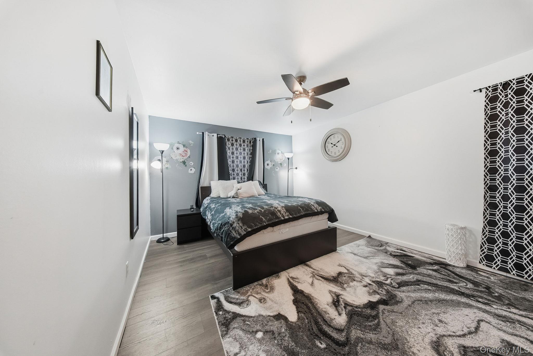 4 Ray Lane Loch Sheldrake, NY 12759 - Photo 14 of 29 a bedroom with a bed and a chandelier