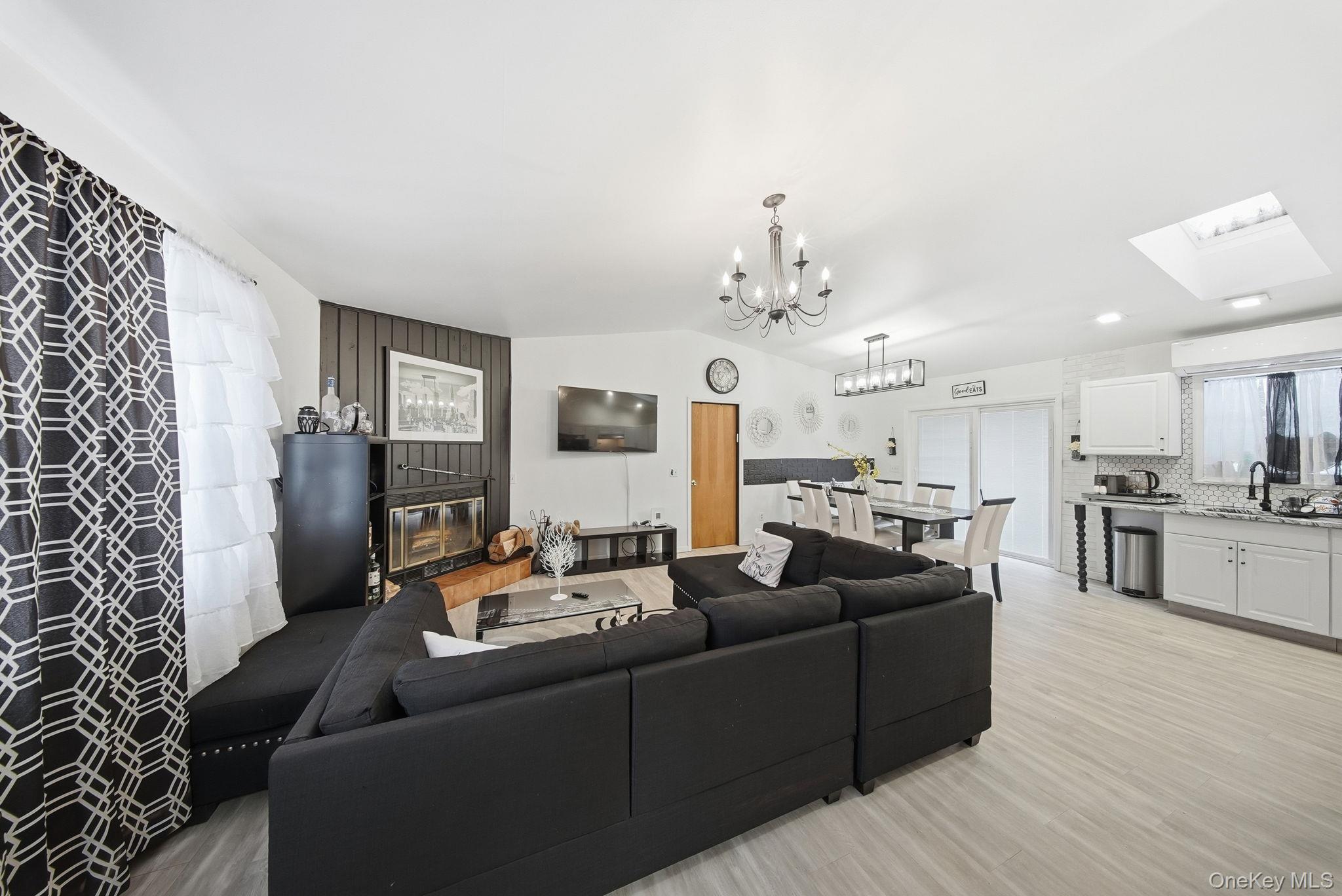 4 Ray Lane Loch Sheldrake, NY 12759 - Photo 4 of 23 a living room with furniture and a chandelier