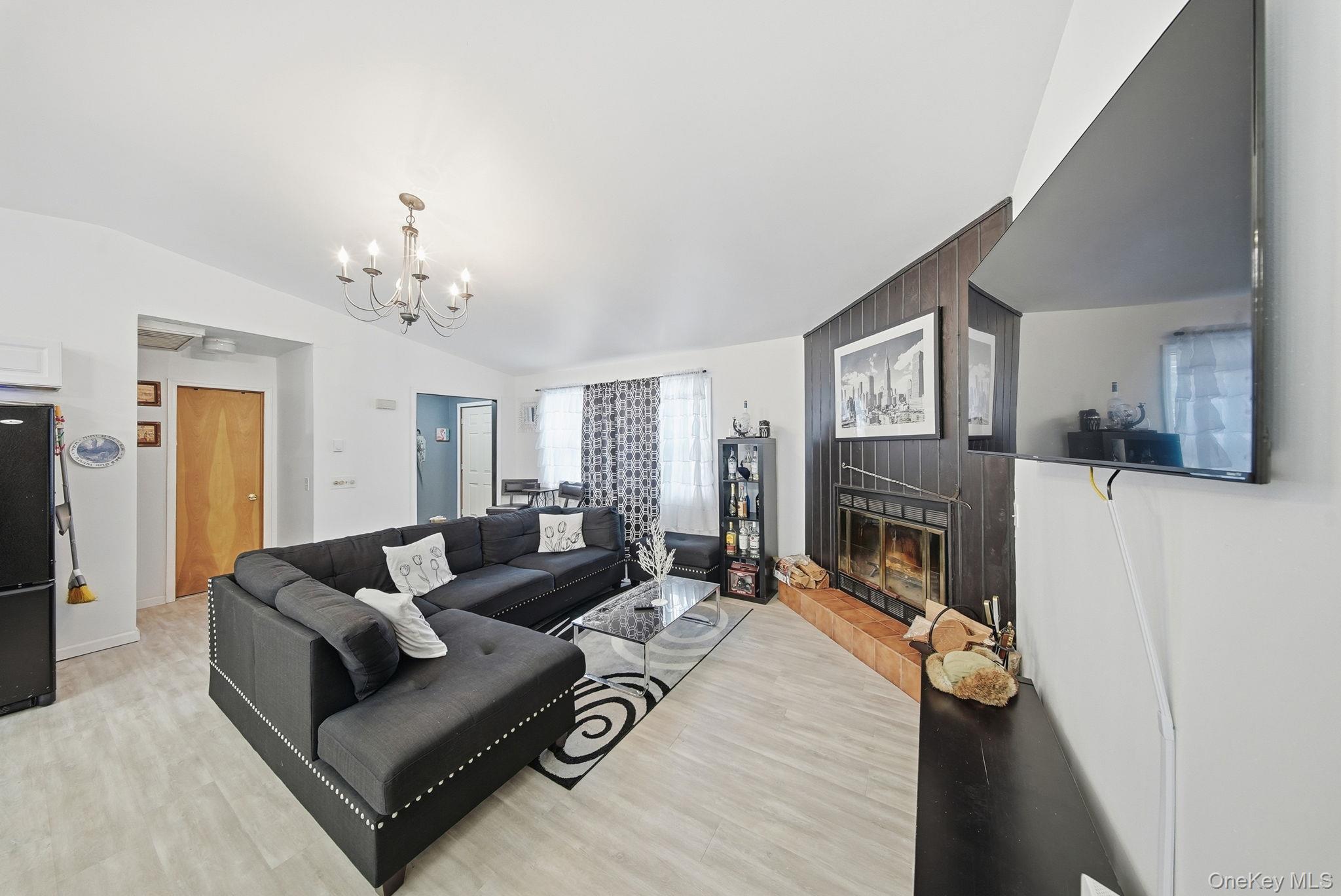 4 Ray Lane Loch Sheldrake, NY 12759 - Photo 5 of 23 a living room with furniture and a fireplace