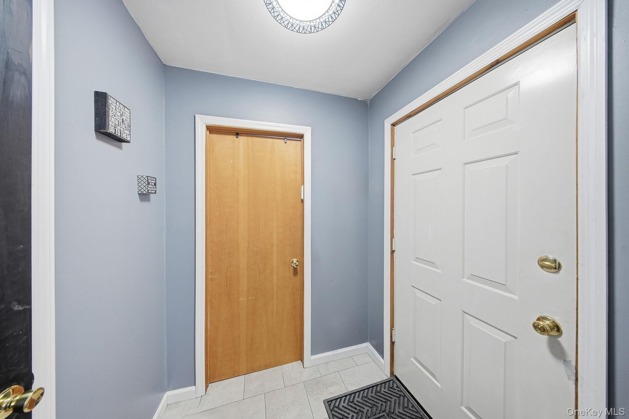 4 Ray Lane Loch Sheldrake, NY 12759 - Photo 5 of 29 Doorway featuring tile patterned floors and baseboards