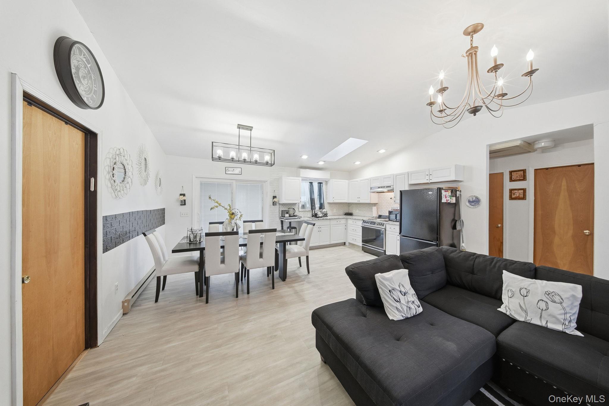 4 Ray Lane Loch Sheldrake, NY 12759 - Photo 7 of 23 a living room with furniture a chandelier and a dining table