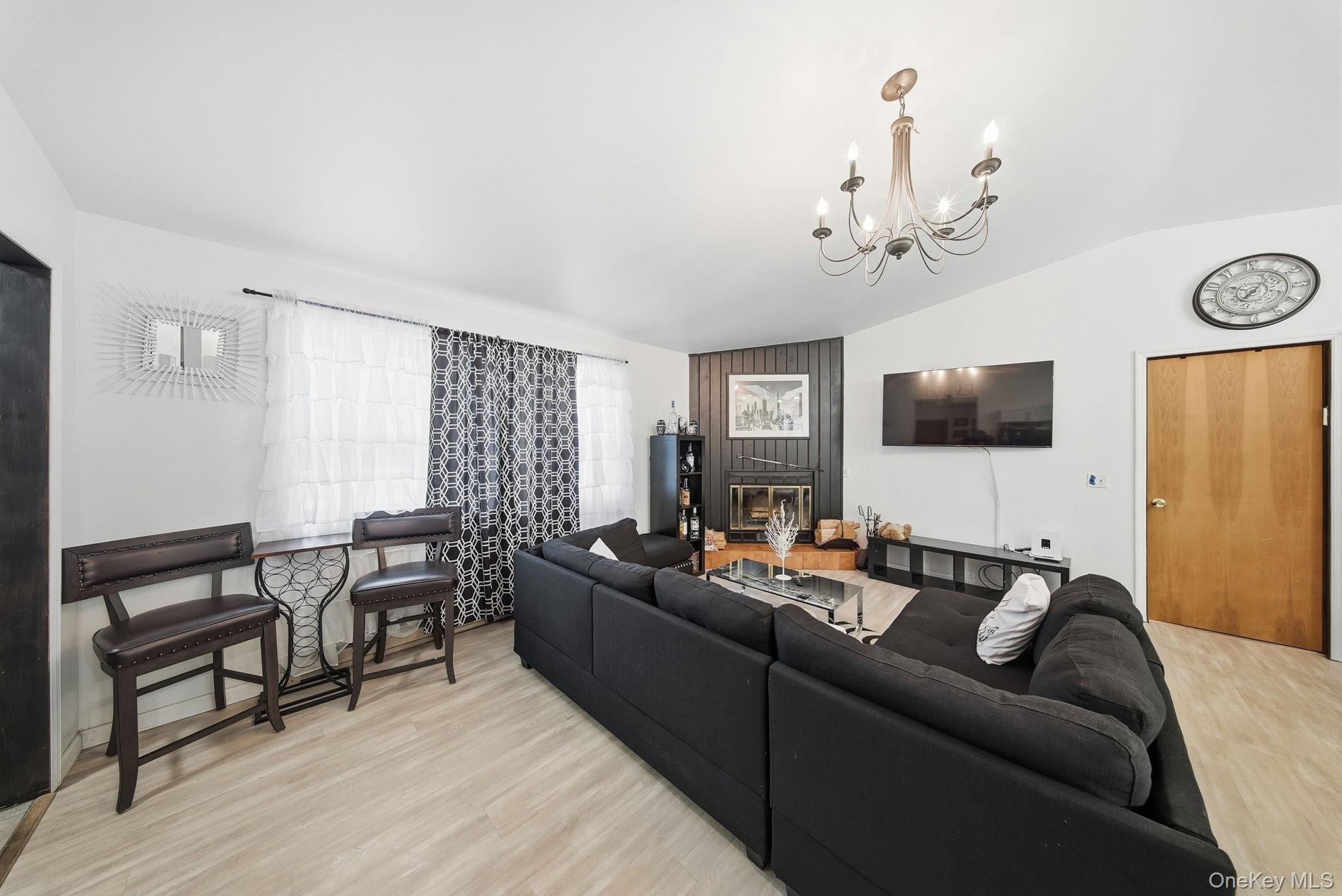 4 Ray Lane Loch Sheldrake, NY 12759 - Photo 8 of 29 a living room with furniture wooden floor and a flat screen tv