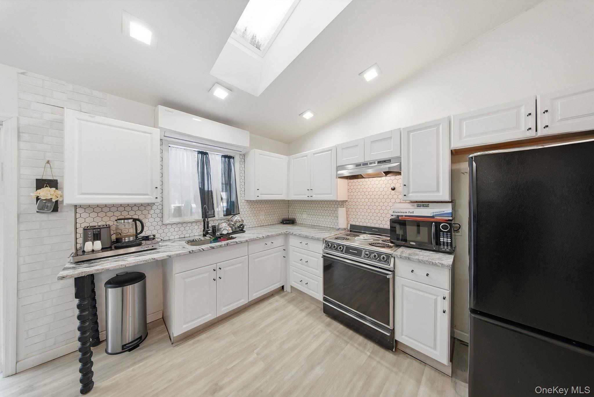 4 Ray Lane Loch Sheldrake, NY 12759 - Photo 8 of 23 a kitchen with a sink stove and refrigerator