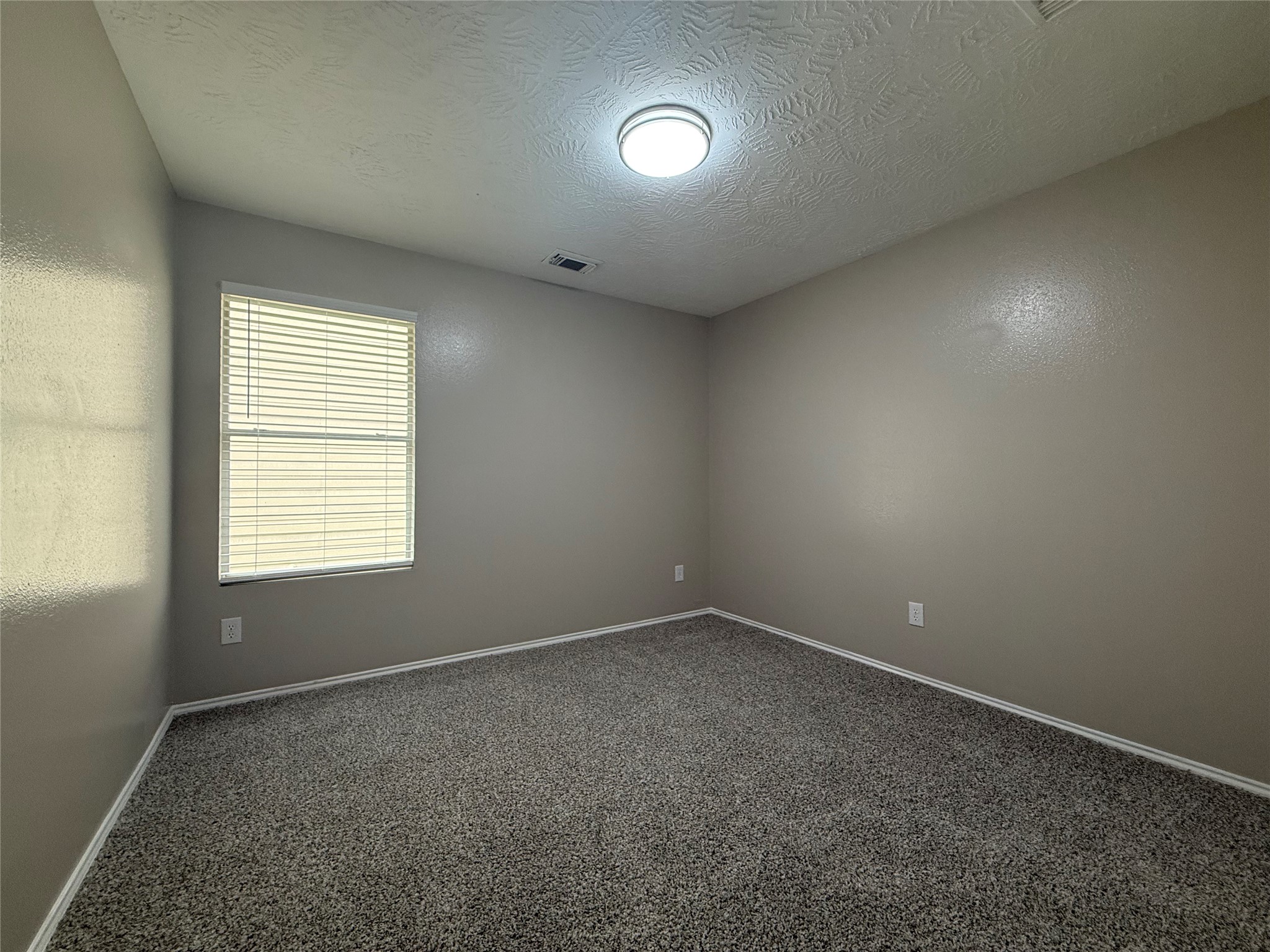 11423 Moonlight Ridge Drive Humble, TX 77396 - Photo 12 of 19 Secondary bedroom without any furniture.