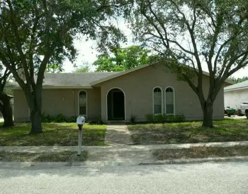 a house that has a tree in front of it