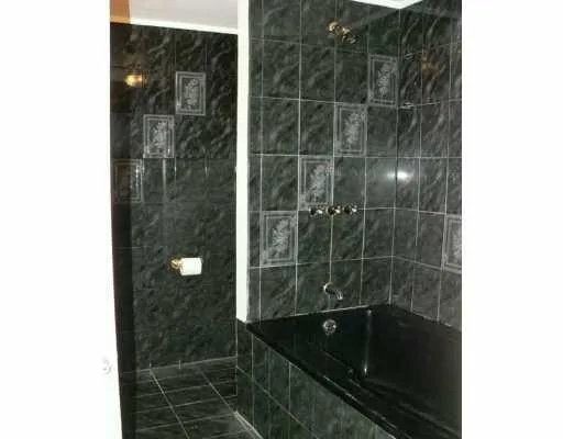 a bathroom with a glass shower door and a sink