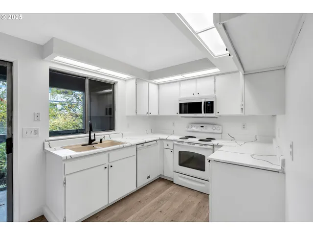 a kitchen with a sink stove and microwave