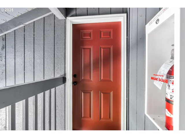 a living room with fish tank and a bookshelf