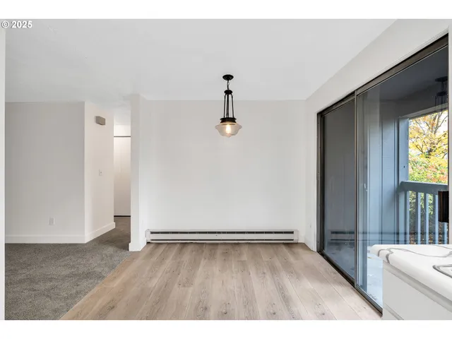 a view of an entryway with wooden floor