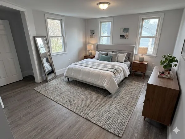 a bedroom with a large bed and a window