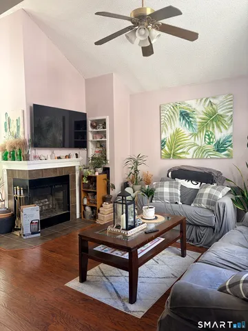 a living room with furniture a fireplace and a flat screen tv