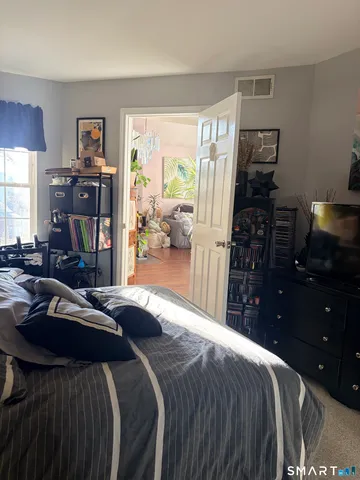 a bedroom with a bed and a couch