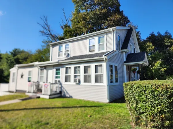 a view of a house with backyard and sitting area