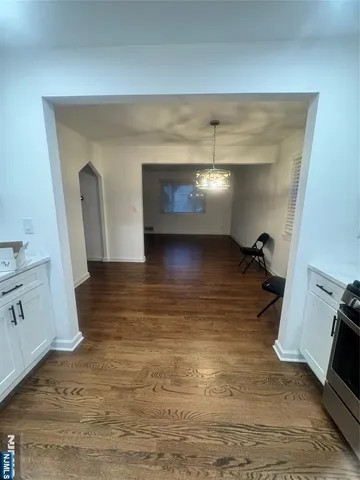 a view of a livingroom with wooden floor and a sink