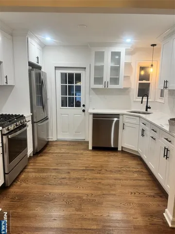 a large kitchen with a stove sink and refrigerator