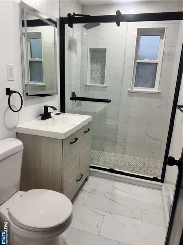 a bathroom with a sink toilet and shower