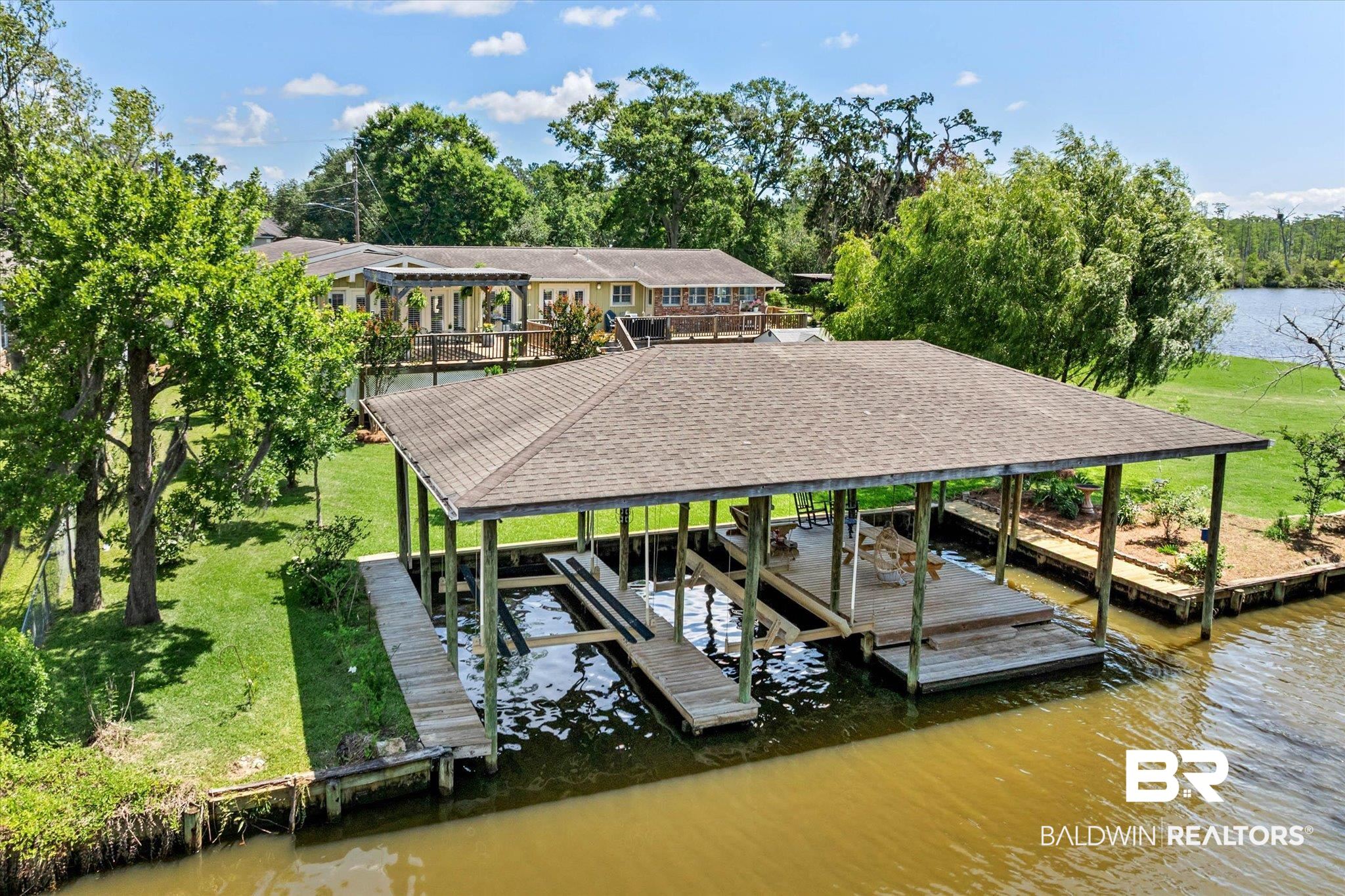3801 Point Road Mobile, AL 36619 - Photo 50 of 55 Covered boat dock with two lifts and a seating area, situated on a substantial waterfrontage