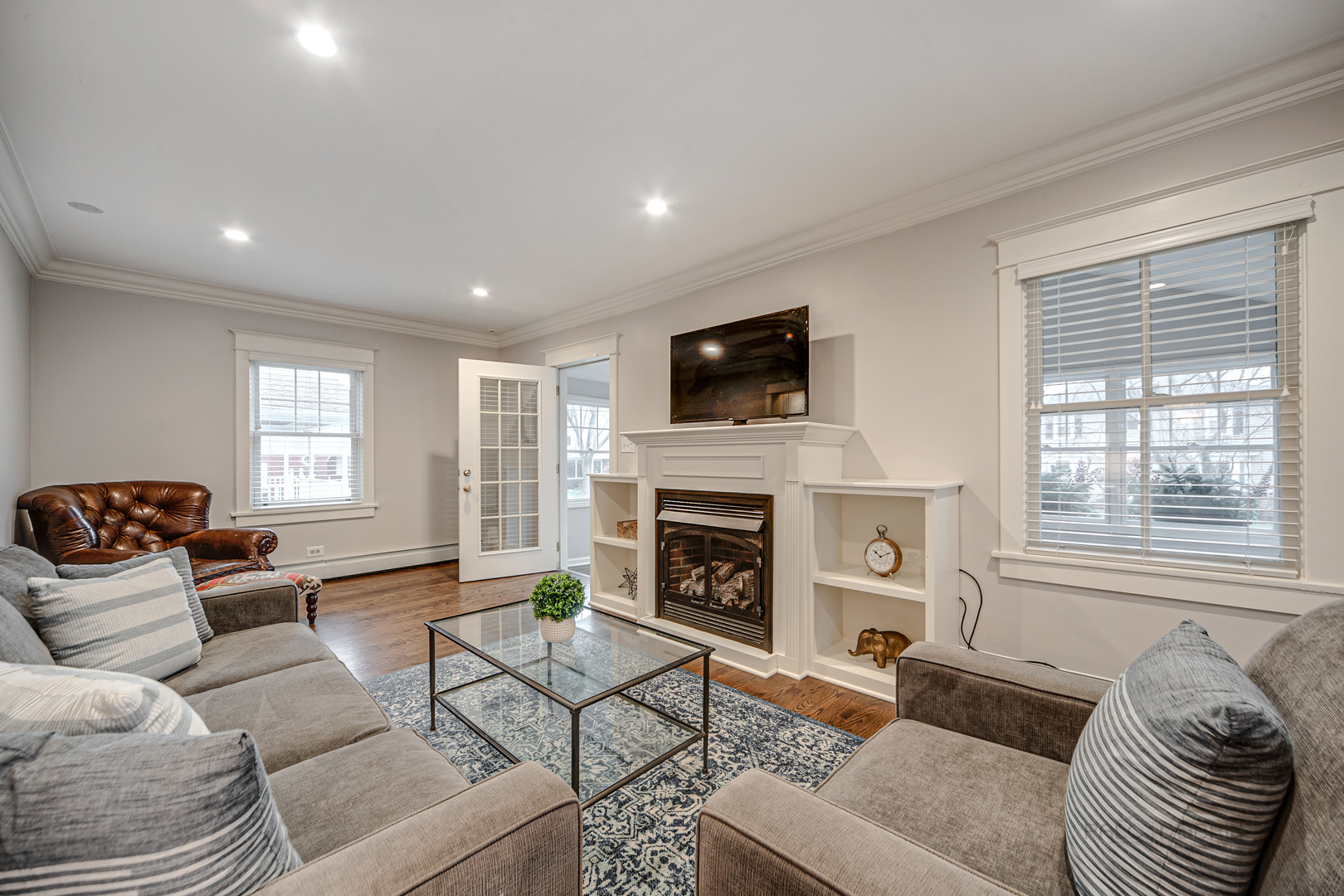 1214 Griffith Road Lake Forest, IL 60045 - Photo 4 of 24 a living room with furniture a fireplace and a flat screen tv