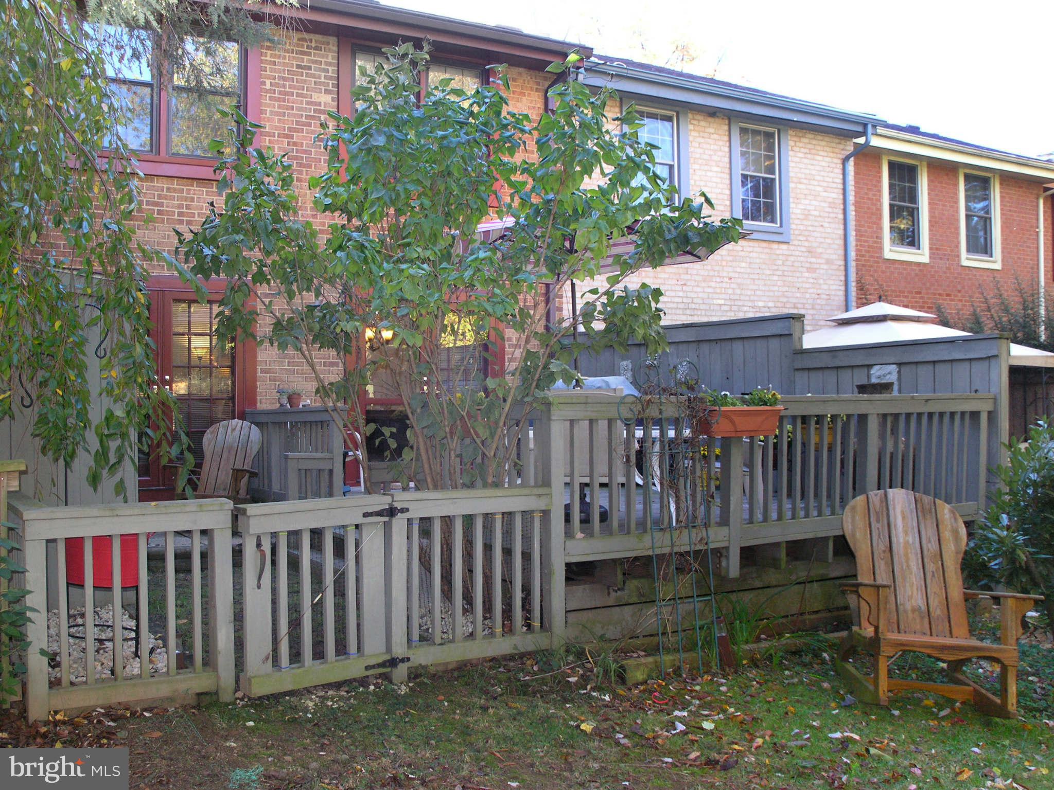 2168 Golf Course Drive Reston, VA 20191 - Photo 20 of 30 a view of a deck with a chairs and a yard