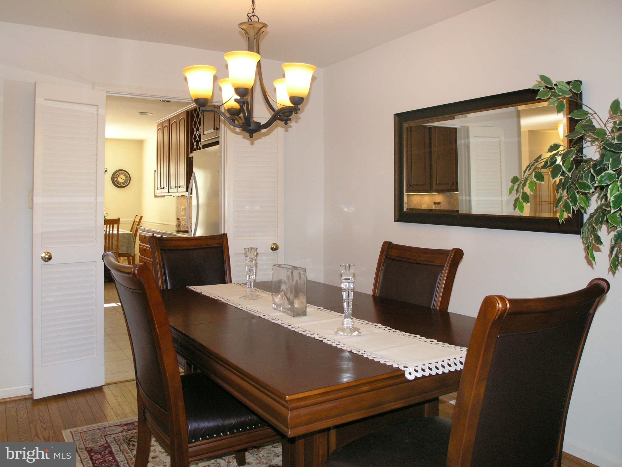 2168 Golf Course Drive Reston, VA 20191 - Photo 8 of 30 a view of a dining room with furniture and chandelier