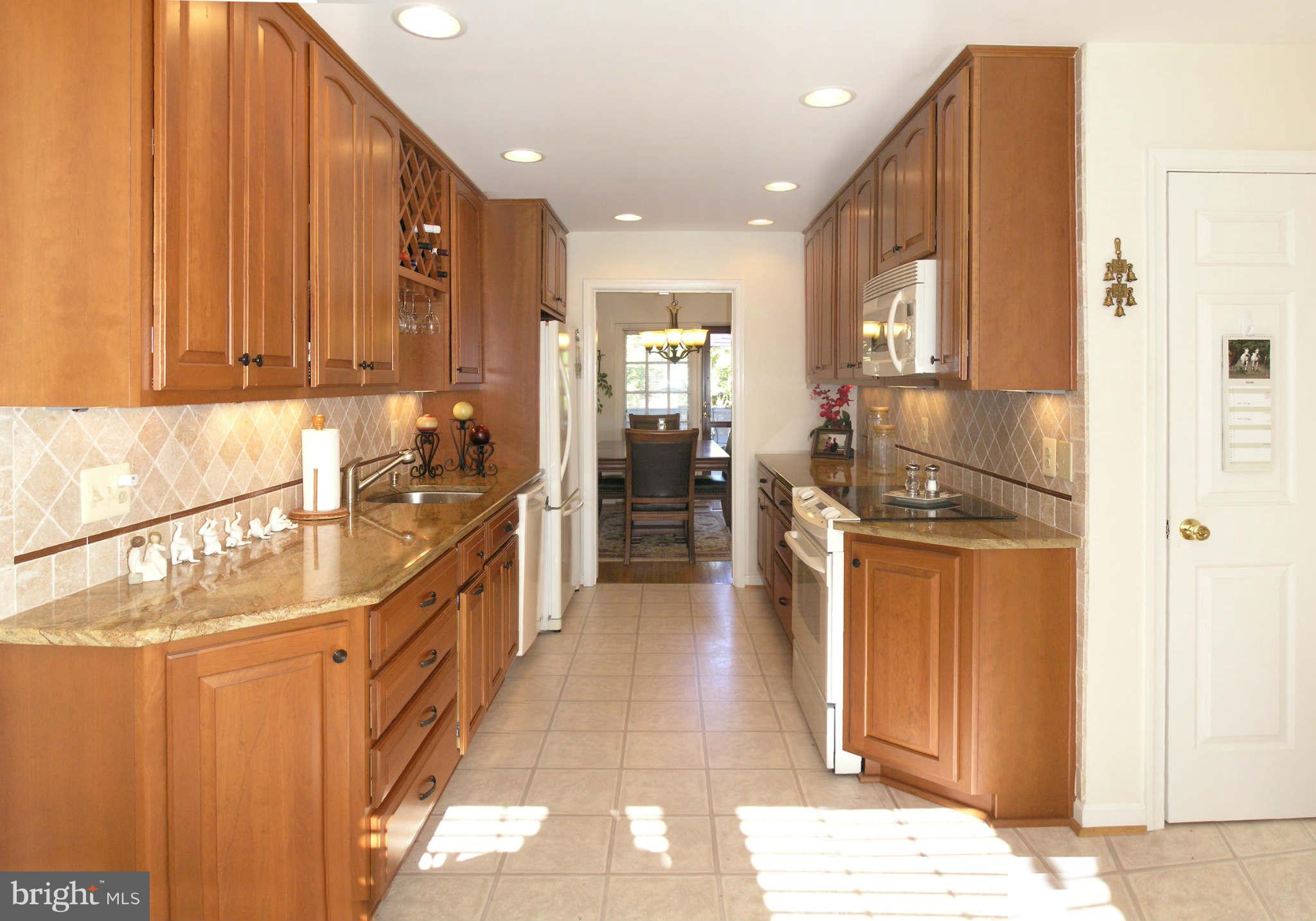 2168 Golf Course Drive Reston, VA 20191 - Photo 9 of 30 a kitchen with stainless steel appliances granite countertop a refrigerator and a sink