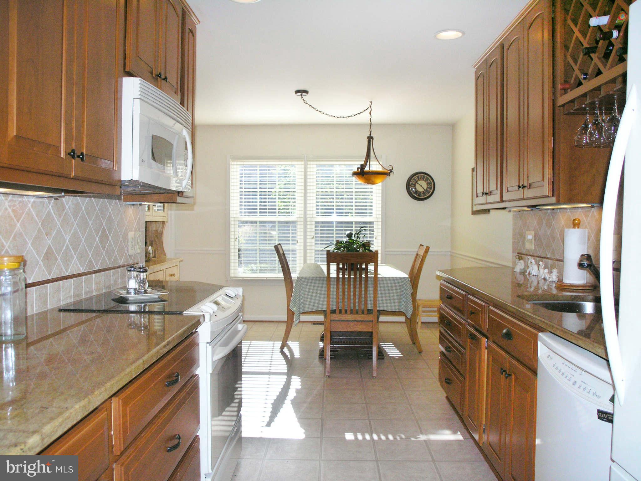 2168 Golf Course Drive Reston, VA 20191 - Photo 10 of 30 a kitchen with granite countertop a sink and a stove top oven