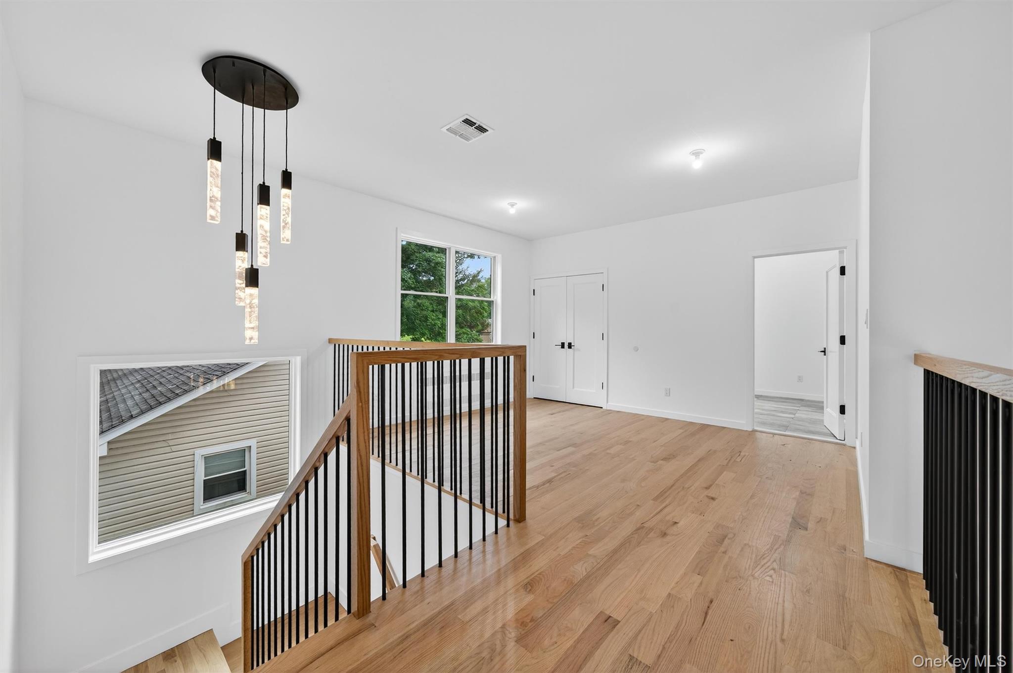 3 Forshee Street Monroe, NY 10950 - Photo 25 of 43 a view of a hallway with wooden floor and chandelier