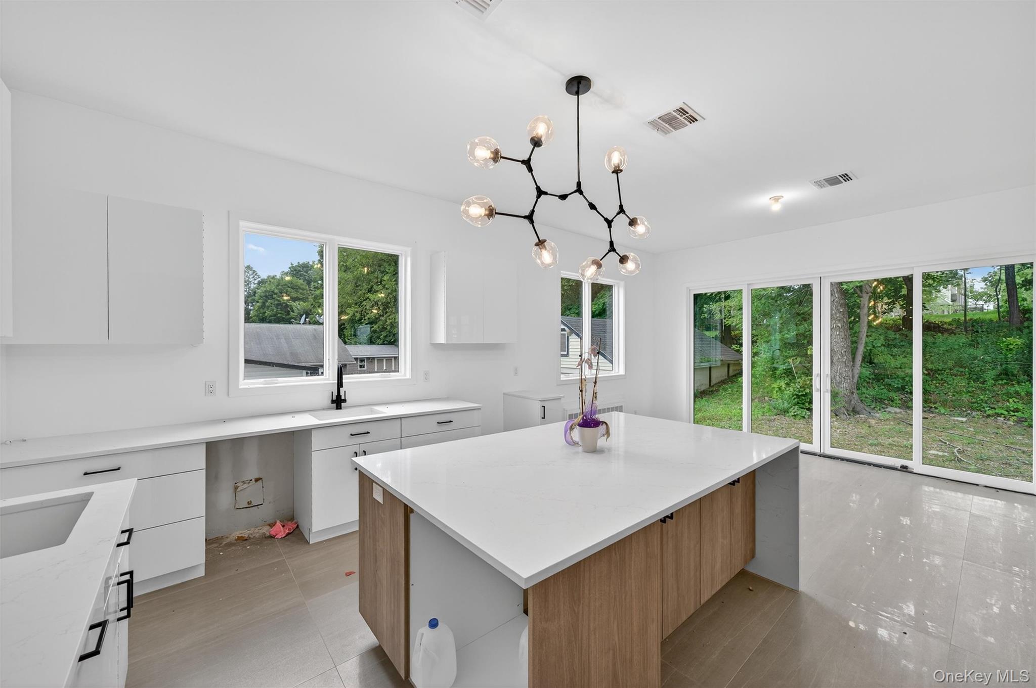 3 Forshee Street Monroe, NY 10950 - Photo 8 of 43 a kitchen with a stove a sink a center island and windows