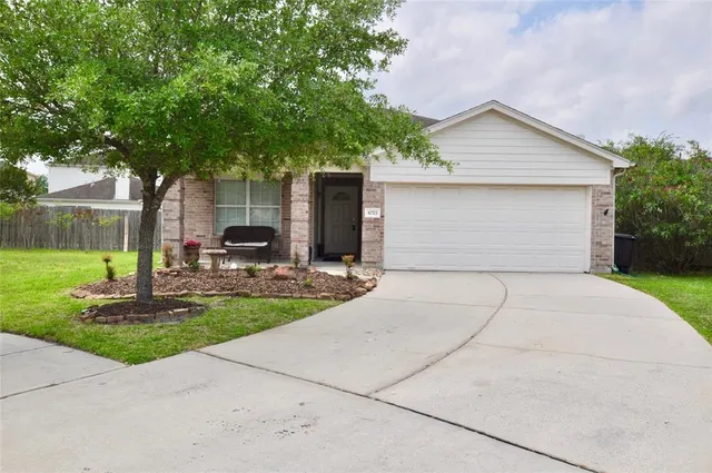 a front view of house with yard and trees