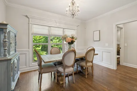 a bedroom with a bed window and a table